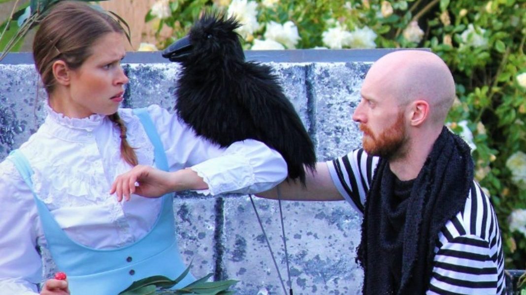 Alice's Adventures In Wonderland Alice and another actor in the garden with a bird