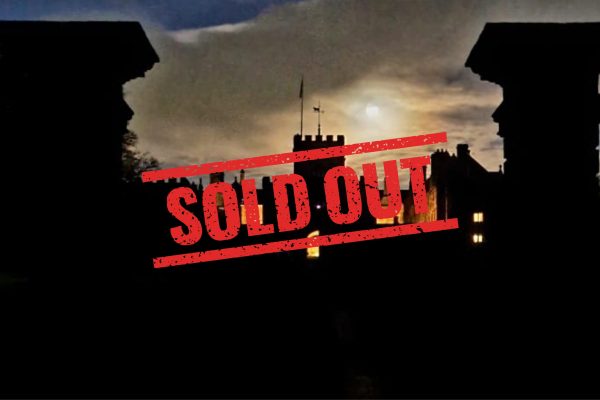 Picture of Hoghton Tower exterior in the dark with the sign sold out on it.