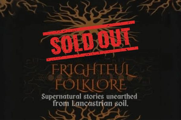 Gothic-style lantern lighting a dark corridor at Hoghton Tower during the Frightful Folklore with sold out sign across in red