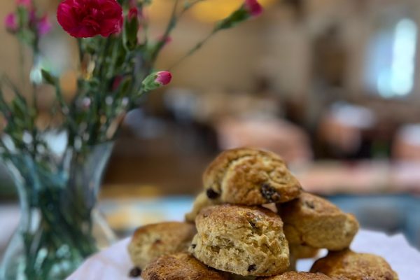 Freshly baked scone with clotted cream and strawberry jam served at the Hoghton Tower Tearoom in Lancashire.