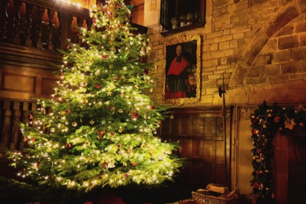 Hoghton in Harmony choir performing traditional Christmas carols by the fireside in the historic Banqueting Hall at Hoghton Tower, December 2025.