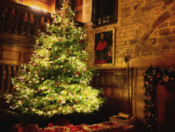 Christmas carols Hoghton in Harmony choir performing traditional Christmas carols by the fireside in the historic Banqueting Hall at Hoghton Tower, December 2025.